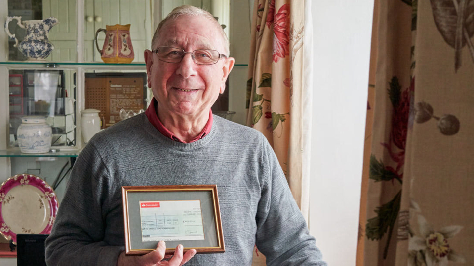 Irvin holding a framed cheque